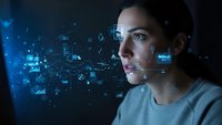 Young Hispanic woman interacting with futuristic holographic interface displaying data analytics and digital network connections in modern tech environment.
