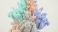 Colorful ink clouds swirling in water creating abstract fluid motion with green orange and purple hues for creative design projects.