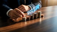 Business professional protecting growing coin stacks with 2024 text representing financial growth planning and investment strategy for new year success.
