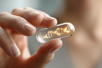 Glowing DNA helix structure inside transparent medical capsule held between fingers against blurred background, representing genetic medicine and biotechnology research.
