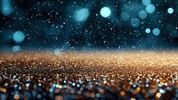 Magical glowing bokeh background with golden glitter scattered on surface and turquoise blue lights floating in dark space creating dreamy atmosphere.