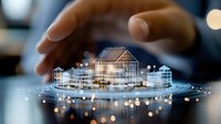 Glowing holographic houses and coins floating above business desk with protective hand gesture, representing real estate investment and property technology.