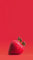 Fresh ripe strawberry with green leaves isolated on vibrant red background, minimalist food composition with soft shadow and copy space for text.
