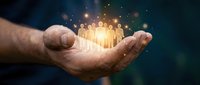Businessman's hand holding glowing group of people icons with sparkling light effects, representing teamwork, network connection, and human resources management for corporate solutions.
