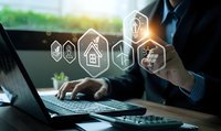 Professional businessman using laptop with digital innovation icons representing smart home technology, energy efficiency and sustainable solutions.