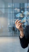Businesswoman in dark suit interacting with glowing cloud computing icons, data analytics symbols, and network connectivity graphics in modern office with city skyline background.