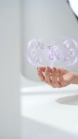 Woman's hands holding glowing holographic cybersecurity icons with shields, locks, and documents in a futuristic digital interface concept.