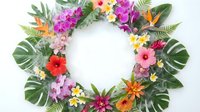 Tropical flower wreath with vibrant hibiscus, plumeria and exotic blooms on white background. Colorful floral circle frame for summer decorations.