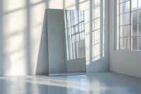 Minimalist interior with window light casting geometric shadows on white walls and polished concrete floor. Empty modern loft space with natural daylight.