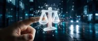 Digital justice concept with glowing scales of law symbol floating above businessman hand in futuristic technology environment for legal services.