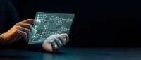 Engineer or technician with medium skin tone holding transparent digital tablet displaying holographic circuit board schematics and technical blueprints against dark background for engineering, technology, and innovation concepts.