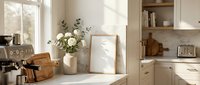 Bright kitchen counter with white flowers in ceramic vase, blank frame, wooden utensil holder, and open shelving with cookbooks and decor. Natural light from window.