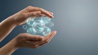 Hand holding glowing digital sphere with floating bubbles against gray background, representing technology, innovation, and data concepts for business applications.