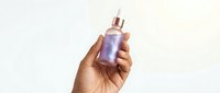 Hand of a dark-skinned woman holding a holographic glass dropper bottle with serum on a light background for beauty and skincare branding.