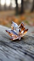 Crystal maple leaf on weathered wood surface with soft bokeh background, combining autumn colors and sparkle in elegant decorative piece.
