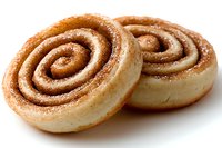 Fresh baked cinnamon rolls with swirled brown sugar filling and light dusting of sugar, shown in close up on white background, ready for breakfast.