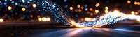 Glowing blue light trail with bokeh effects creates dynamic motion against dark background, illuminated by warm city lights in evening atmosphere.