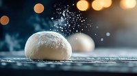 Raw dough ball with flour dust explosion against dark background with golden bokeh lights, dramatic food photography on rustic wooden surface.
