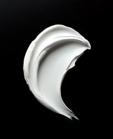 White cream swirl isolated on black background, suitable for cosmetics, skincare, and beauty product packaging design applications.