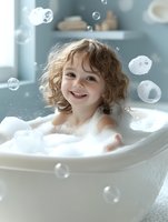 Joyful child with curly hair enjoying bubble bath time, surrounded by soap bubbles and foam in white bathtub against soft blue bathroom wall.