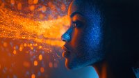 Young African woman profile in dramatic orange and blue lighting with glowing particles and water drops creating mystical atmospheric effect. Artistic portrait captures ethereal beauty.