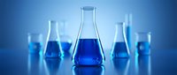 Laboratory glassware with blue chemical solutions on gradient background for scientific research and experimentation in modern chemistry lab.