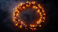 Glowing wreath of warm yellow fairy lights creating magical circular frame against dark background, festive holiday decoration for celebrations.