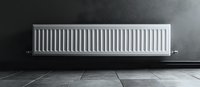Modern white panel radiator mounted on dark wall with tiled floor, minimalist home heating solution for interior design and architecture projects.