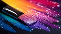 Colorful makeup brush on vibrant rainbow eyeshadow palette with glitter particles and powder texture, macro photography for cosmetics and beauty industry.