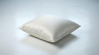 Soft cream linen throw pillow on a light gray surface, showcasing minimalist home decor with a clean, neutral aesthetic for interior design.