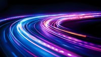 Curved light trails in neon blue and purple colors against black background create dynamic motion effect, suitable for technology and innovation concepts.