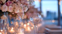 Elegant wedding table setting with pink roses, crystal wine glass, and glowing candles creating romantic atmosphere for luxury reception or celebration.
