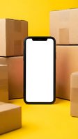 Smartphone with blank white screen surrounded by cardboard shipping boxes on bright yellow background for delivery app mockup and e-commerce business concept.