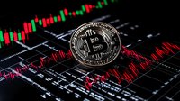 Silver cryptocurrency coin on digital trading chart with red and green candlesticks showing market volatility and price movement analysis.