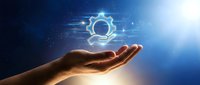 Technician hand holding glowing gear icon with digital circuit lines on blue background, representing technology support, innovation, and engineering solutions.