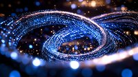Glowing blue spiral of light particles with bokeh effect on dark background creates magical cosmic atmosphere. Suitable for technology and innovation designs.