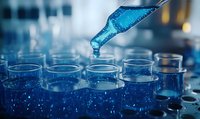 Blue liquid drops from pipette into laboratory test tubes filled with glowing solution, creating dramatic scientific research atmosphere in modern lab setting.