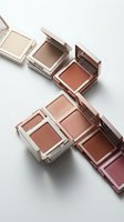Luxury makeup compact collection featuring neutral and warm-toned eyeshadows and blush in rose gold packaging on clean white background.