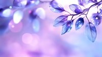 Ethereal blue leaves with soft pink bokeh background create dreamy natural composition. Delicate translucent foliage glows with magical purple and blue hues in gentle light.