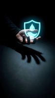 Hand holding glowing neon shield with water droplet icon against dark background, representing protection, security, and environmental conservation concepts.