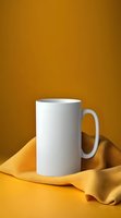 White ceramic mug mockup on yellow background with textile fabric. Clean minimal product photography setup for branding and merchandise design.