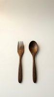 Wooden fork and spoon set on neutral beige background for kitchen dining and eco-friendly cooking utensils flatlay minimalist style.