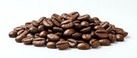 Roasted coffee beans pile isolated on white background for cafe menu design and beverage advertising materials.