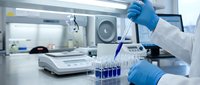 Laboratory scientist in blue gloves conducting research with test tubes and pipette in modern medical facility for pharmaceutical development.