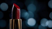Deep red metallic lipstick in luxurious gold tube against dark background with soft bokeh lights, elegant cosmetic product photography for beauty and glamour marketing.