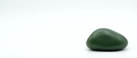 Green jade stone isolated on white background for wellness spa meditation and healing energy practices.