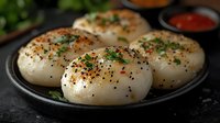 Fresh homemade bread rolls with herbs and spices on dark plate, artisan bakery food photography for culinary blogs and restaurant menus.