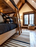 Cozy cabin bedroom with bunk bed, buffalo plaid bedding, striped area rug and window seat nook. Rustic wood beams and warm lighting create inviting mountain retreat atmosphere.