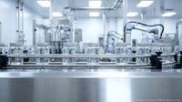 Modern pharmaceutical manufacturing facility with glass vials on conveyor belt system for sterile drug production and quality control processes.