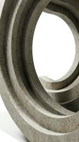 Abstract concrete spiral architecture with curved geometric forms and natural lighting creating modern minimalist design for contemporary projects.